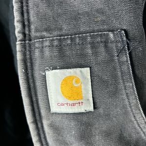 The original black of the jacket has faded.Has some white paint splatters.